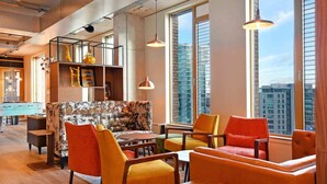 A modern lounge area with a pool table, comfortable seating, and large windows offering city views. - For Student Only Liv Student Sheffield - Campus Accommodation (Sheffield)