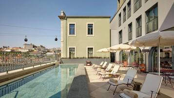 Outdoor pool, open 8:00 AM to 8:00 PM, pool umbrellas, sun loungers