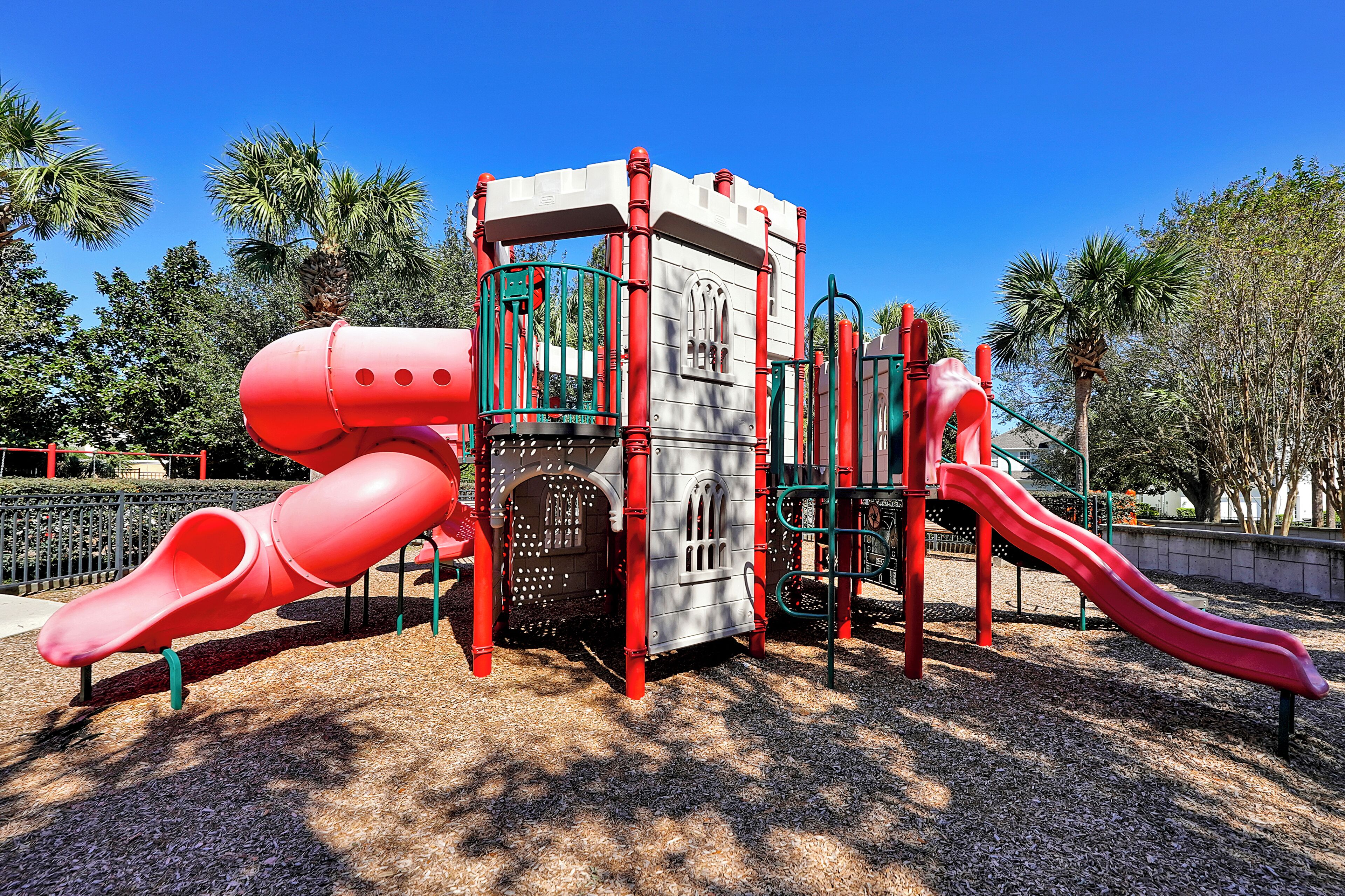 A playground with a slide and climbing structures.