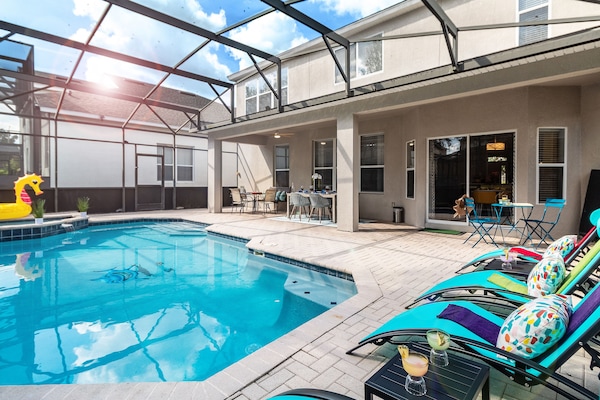 Orlando villa lanai with heated pool, loungers & bistro—relax in style.