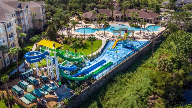 A resort with multiple swimming pools, water slides, and a large water park area.