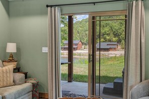 A room with a sliding glass door leading to a deck with outdoor furniture.