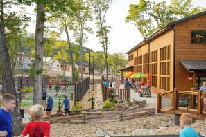 A wooden building with a deck and outdoor seating area.
