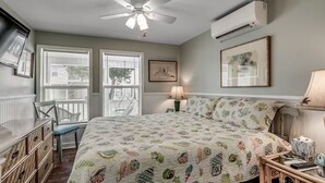 A bedroom with a bed, a chair, a desk, and a window with blinds. - Ultimate vacay home, walk to beach, fenced in yard (North Myrtle Beach)