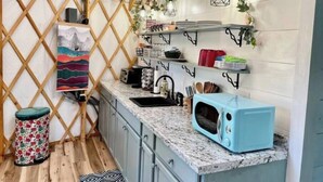 A compact kitchen with a microwave, sink, and various utensils. - Unique Stay! Yurt with Mountain View, 1 min to Breweries & Hiking, 5 min to Lake (Roseland)