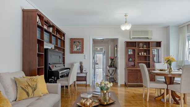 A living room with a sofa, coffee table, and dining area.