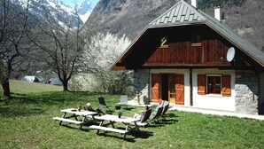 A rustic mountain cabin with a stone exterior, wooden shutters, and a sloped roof. - Chalet 'Savoiage' with Mountain View, Private Terrace and Wi-Fi (Saint-Colomban-des-Villards)