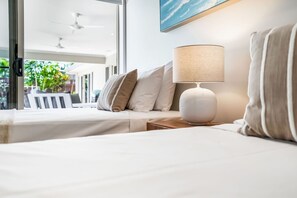 Habitación de hotel con cama, lámpara y vistas al exterior.