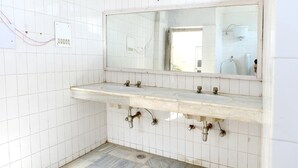 A bathroom with two sinks, a mirror, and visible plumbing. - Shikra Tourist Resort (Dabwali)