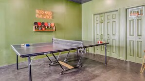 A ping pong table in a room with green walls and a neon sign that reads "WORK HARD PLAY HARDER". - Best Views, Golf/Theater/GameRoom/HotTub7min to Town (Ellijay)