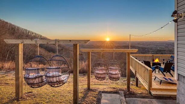 A wooden deck with hanging chairs and a fire pit, overlooking a scenic landscape. - Best Views, Golf/Theater/GameRoom/HotTub7min to Town (Ellijay)