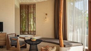 A modern living room with a sofa, a wooden chair, a round coffee table, and a TV. - Chongzuo Wild Stay Collection - Wanxiang (Chongzuo)
