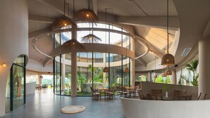 A spacious lobby with a circular layout, large windows, and hanging wicker lamps. - Chongzuo Wild Stay Collection - Wanxiang (Chongzuo)