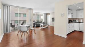A modern apartment with a dining area, a living room, and a kitchen. - Bay Harbor Sunset Apt 5B (Bay Harbor Islands)