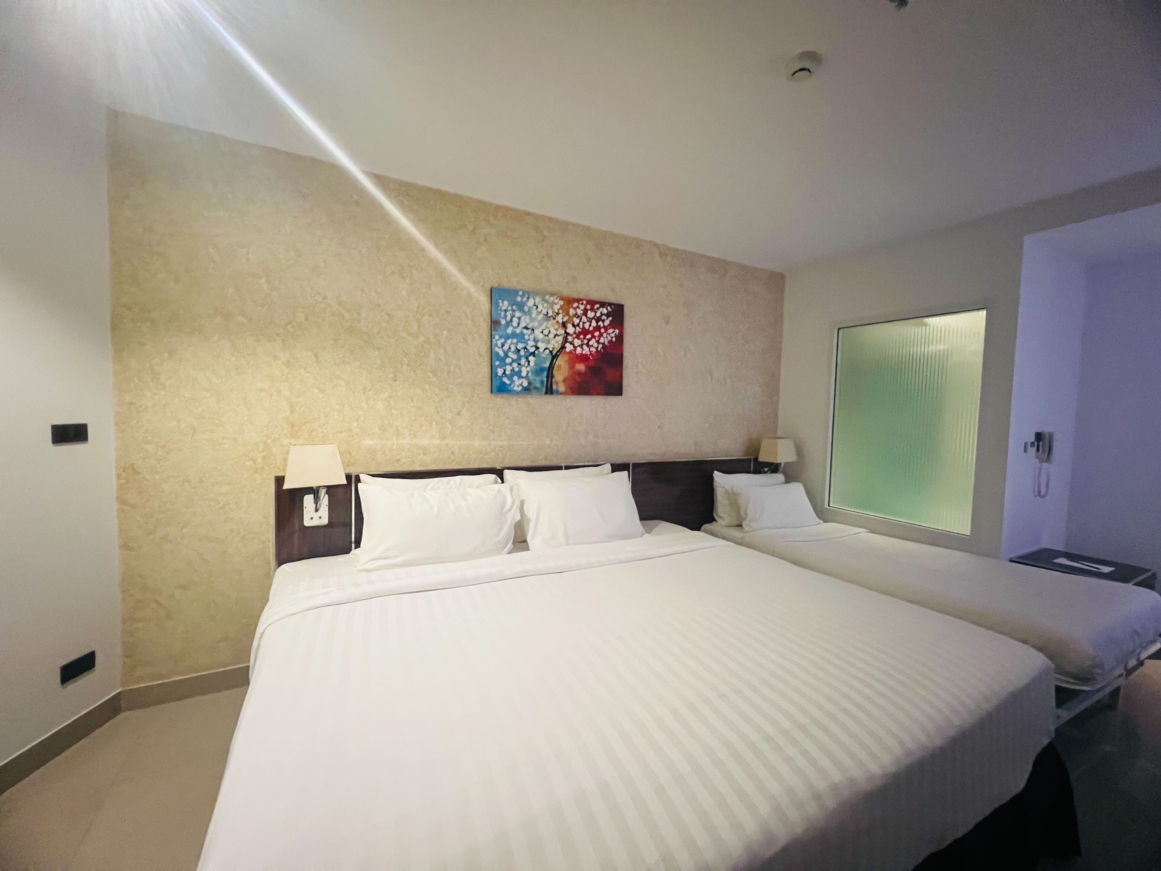 Deluxe Triple Room, City View | In-room safe, desk, laptop workspace, blackout drapes