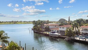 A waterfront property with a dock, boats, and a swimming pool. - Bay Harbor Sunset Apt 5C (Bay Harbor Islands)