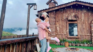 A rustic wooden cabin with a sloped roof, a window, and a small porch area. - Gió Homestay – Măng Đen (Mang Den)