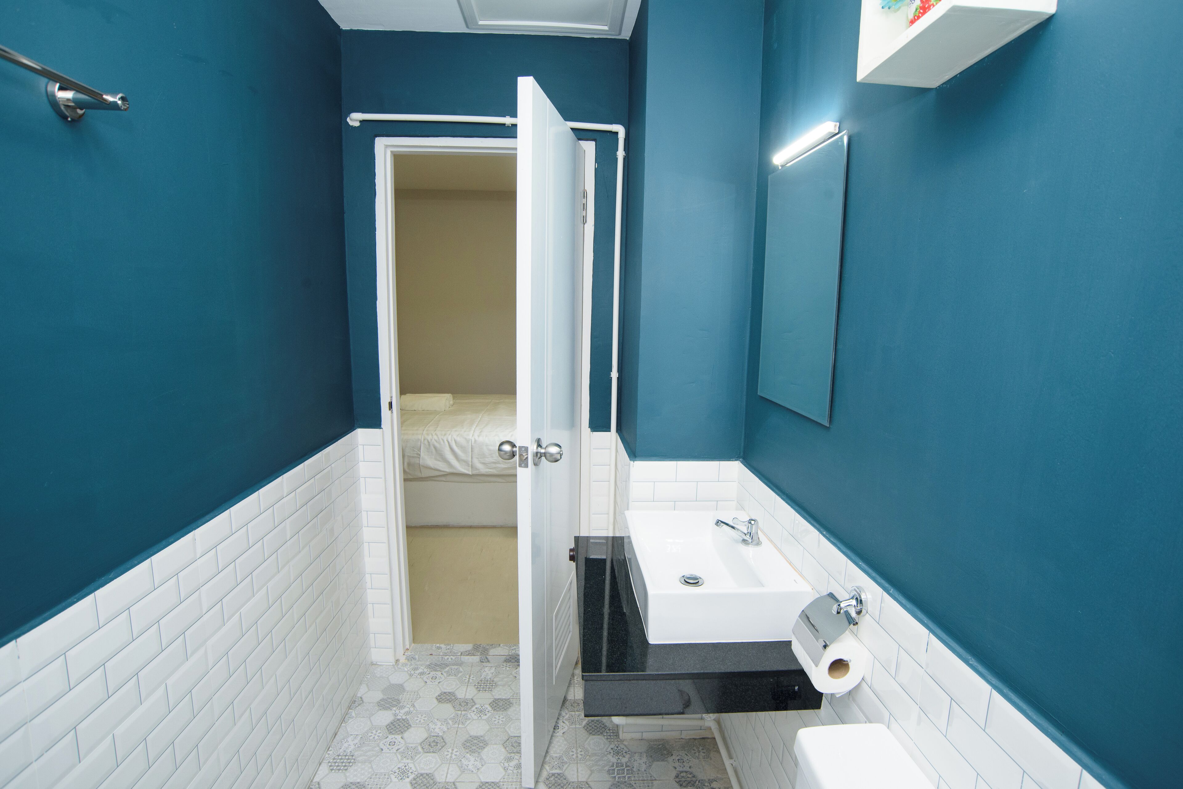 A bathroom with a white sink, a toilet, and a shower area.