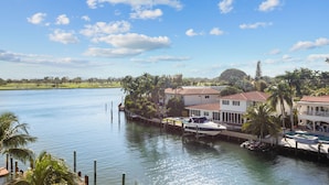 A waterfront property with a dock, boats, and a swimming pool. - Bay Harbor Sunset Two Bedrooms Apt (Bay Harbor Islands)