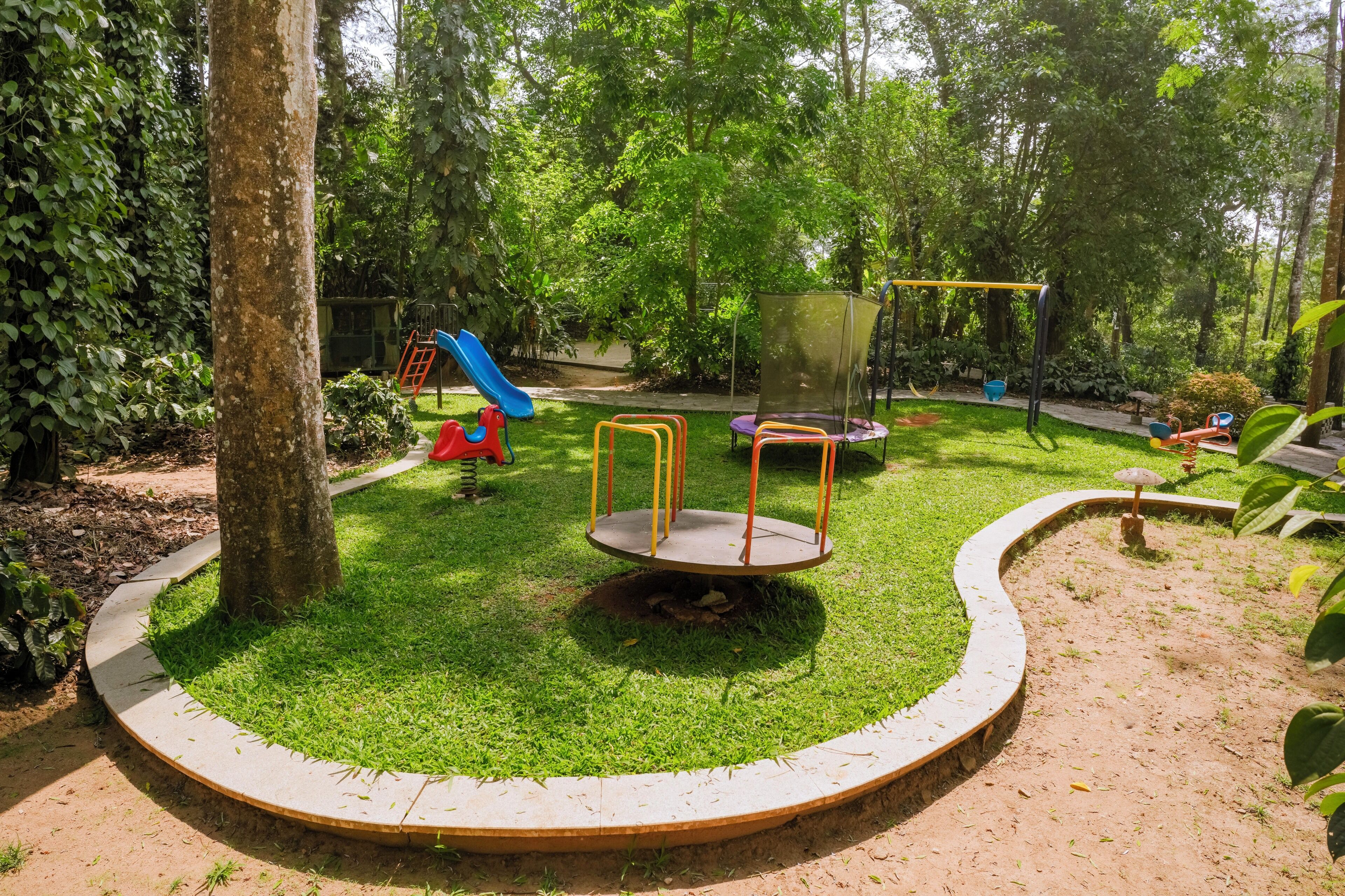 A playground with a slide, swings, and a circular play area.