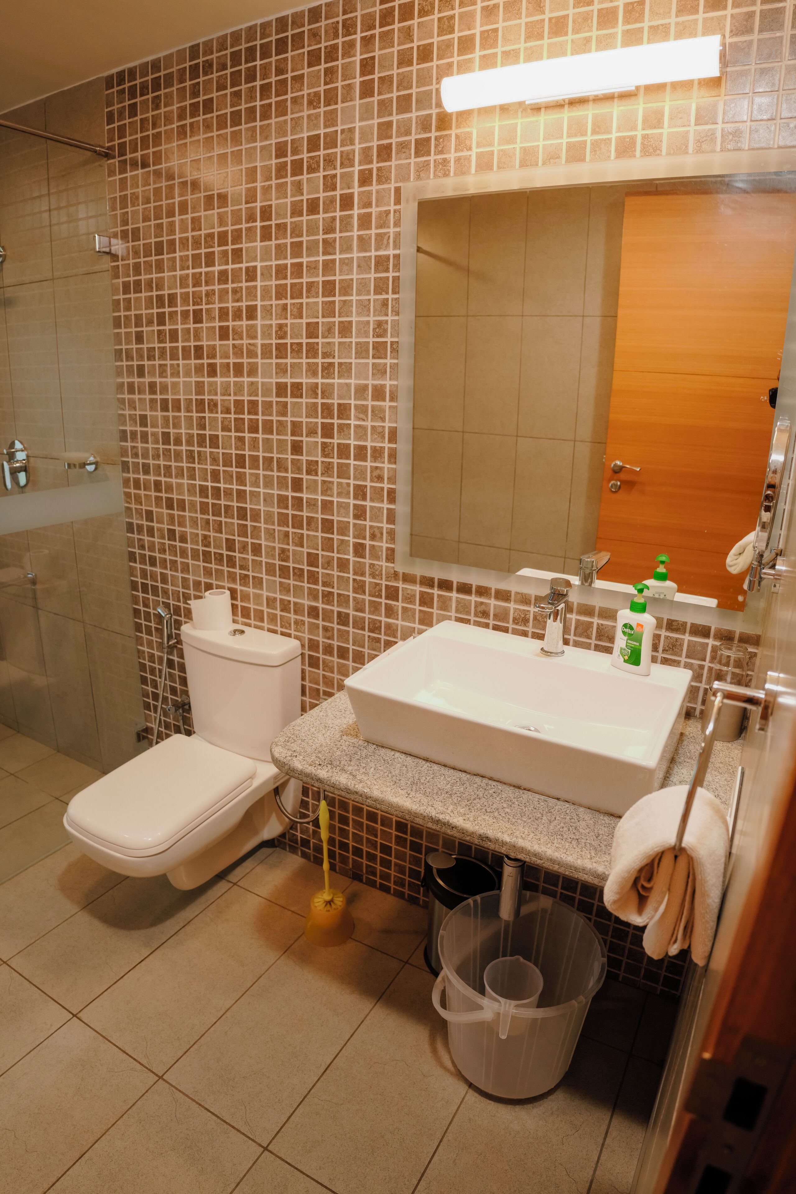 A bathroom with a toilet, sink, and shower.