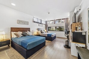 A modern hotel room with two beds, a desk, and a large window with curtains. - Hotel Boutique Emma  (Mexico City)