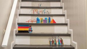 Una escalera con peldaños pintados a mano, que incluyen palabras y diseños coloridos.