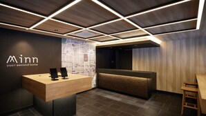 A modern reception area with a wooden desk, a map on the wall, and a seating area with a wooden bench.