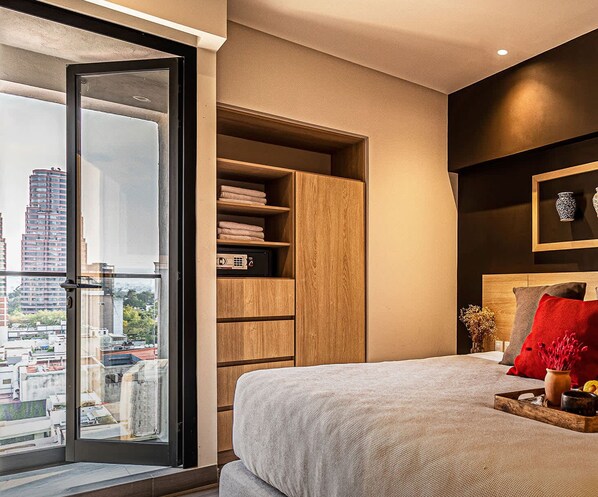 Relax in this stylish bedroom with a large bed, city views, and a bedside table.