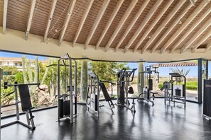 An outdoor gym with various exercise equipment, a covered area, and a view of the surrounding landscape.