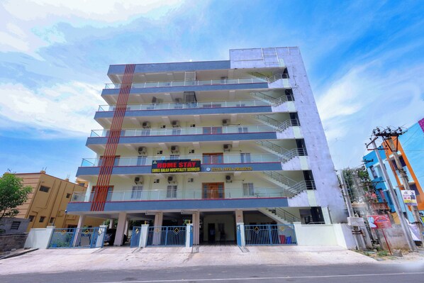 A multi-story building with a sign for 'Home Stay' and 'Shree Balaji Hospitality Services.' - SBHS Homestay - Sheshadri (Tirupati)