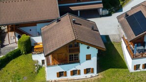 A residential area with multiple houses featuring sloped roofs and a mix of brick and stucco exteriors.