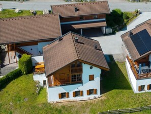 A residential area with multiple houses featuring sloped roofs and a mix of brick and stucco exteriors. - Scenic Valley Chalet in Austria (Wald-Königsleiten)
