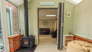 A living room with a fireplace, a sofa, and a coffee table. - Witham View (Lincoln)