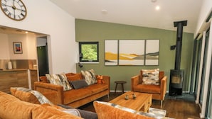 A modern living room with a sofa set, a coffee table, and a fireplace.