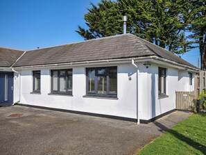 A single-story house with a grey roof, white exterior walls, and black-framed windows. - 6 Trelawney Court (Wadebridge)