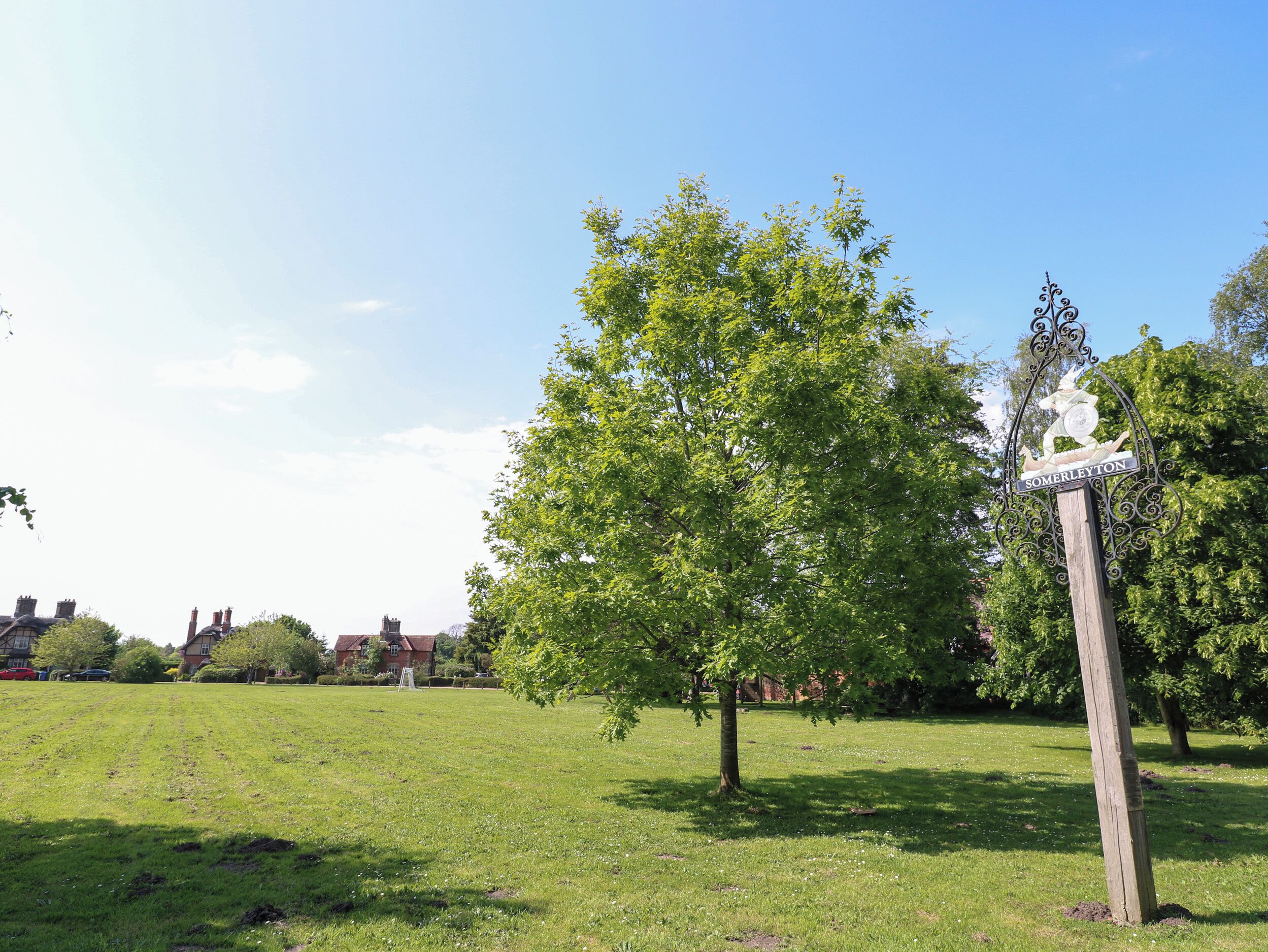 A park with a signpost indicating 'SOMERLEYTON'.