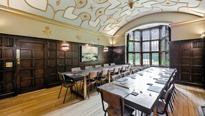 A conference room with a long table, chairs, and a large window. - Tudor Grange (Bournemouth)