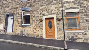 A stone building with multiple windows, a door, and satellite dishes. - 4 Pembroke Street (Skipton)