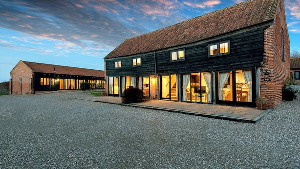 A two-story building with large windows and a gravel driveway. - Snipe (Beccles)