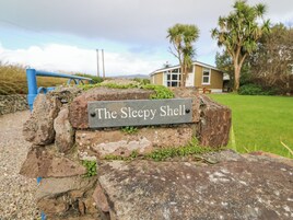 A stone sign with the text "The Sleepy Shell" indicating a location.