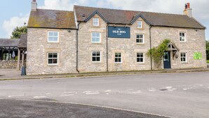 A stone building with a sign reading "The Old Dog The Inn". - Apartment at The Old Dog, Thorpe (Ashbourne)