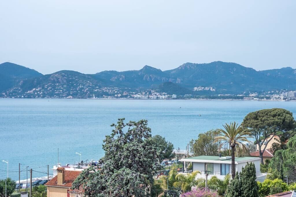 Eine Küstenstadt mit Blick auf das Meer und Berge im Hintergrund.