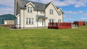 A two-story house with a red deck, a garage, and a well-maintained lawn. - Drummygar Mains (Arbroath)