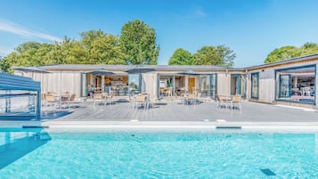A poolside area with outdoor seating and a bar.