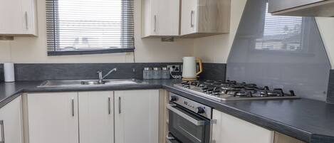 Fridge, electric kettle, cookware/dishes/utensils