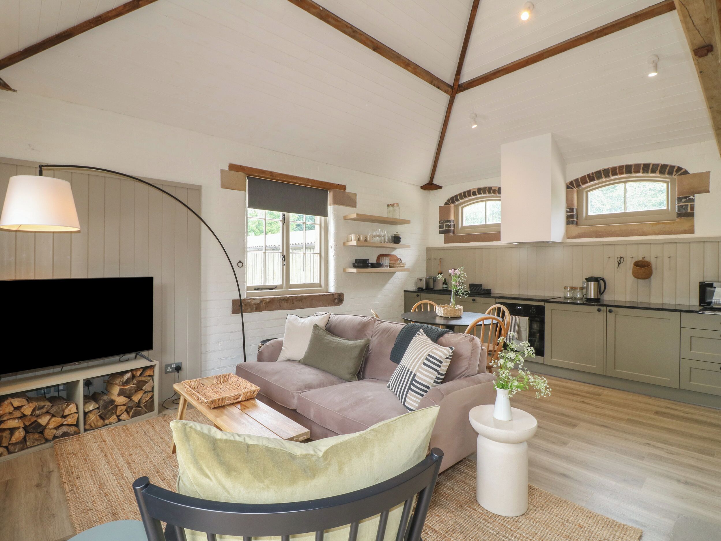 A cozy living room with a sofa, TV, and a fireplace.