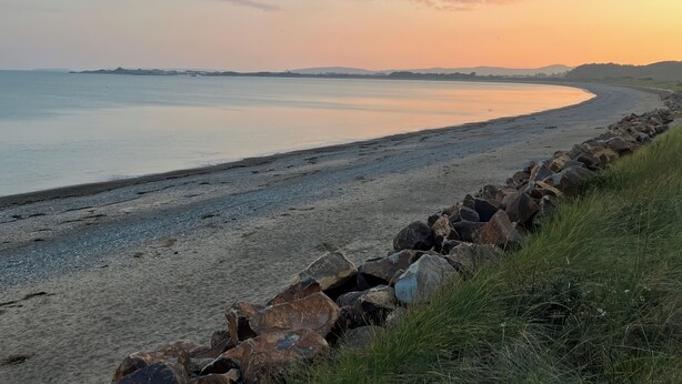 A beach with a rocky shoreline and calm water. - The Mill (Pwllheli)