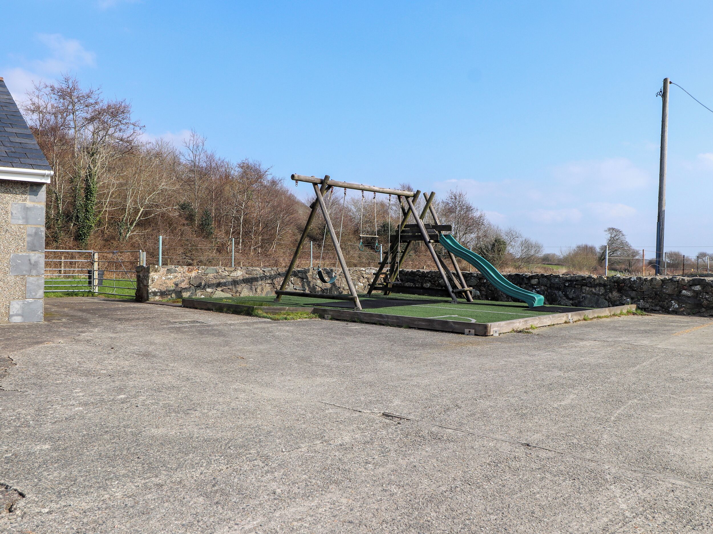 A playground with a swing set and a slide.