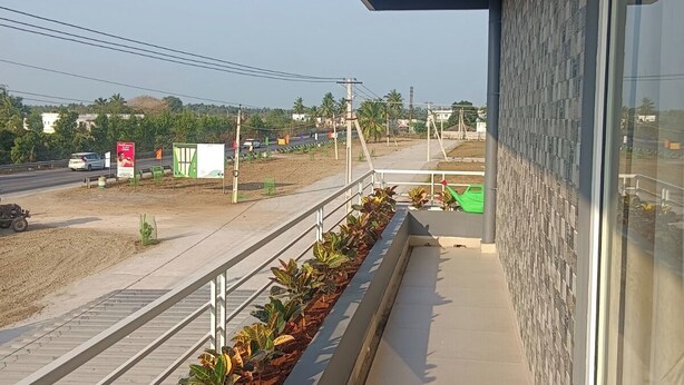 A balcony with a view of a road and buildings.
